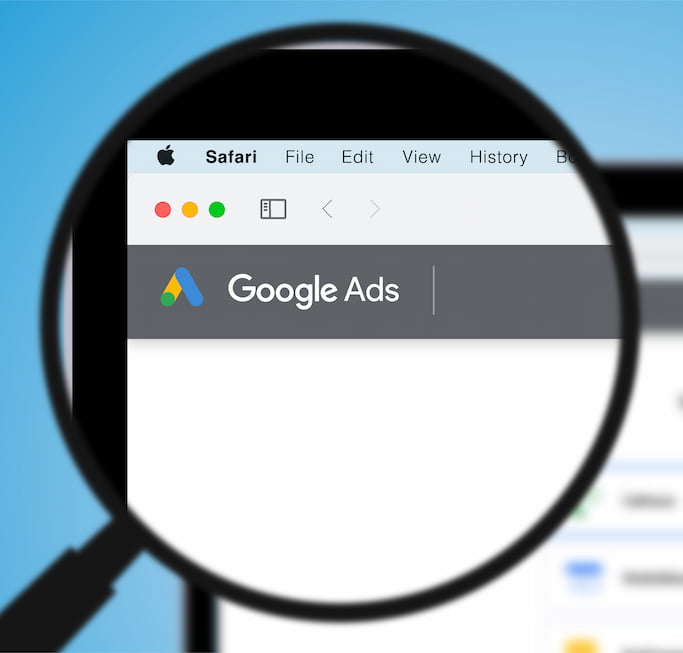 Magnifying glass on corner of website with google ads logo